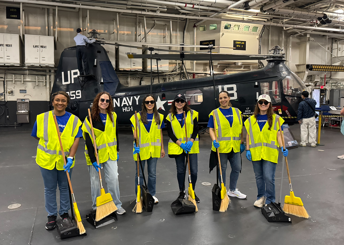 Sempra volunteers in safety gear at the USS Midway