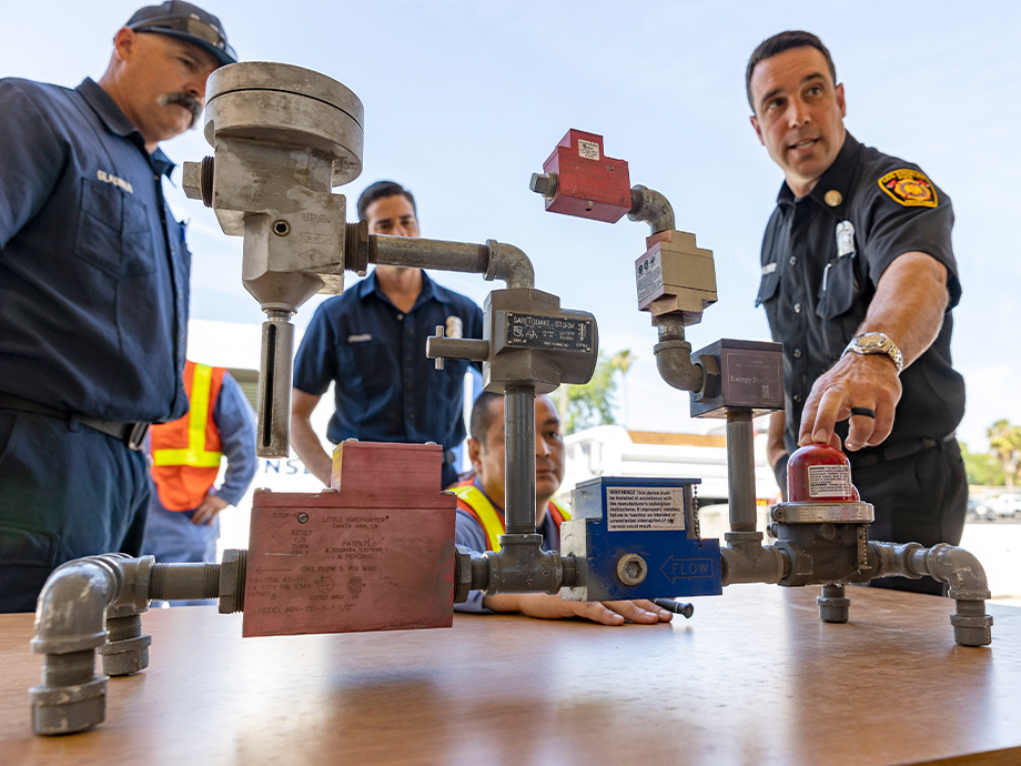 SoCalGas employees discussing a gas gauge