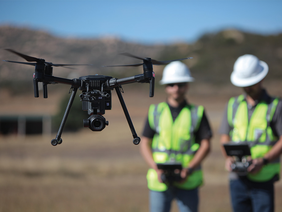 Two SDGE employees piloting a wildfire mitigation drone