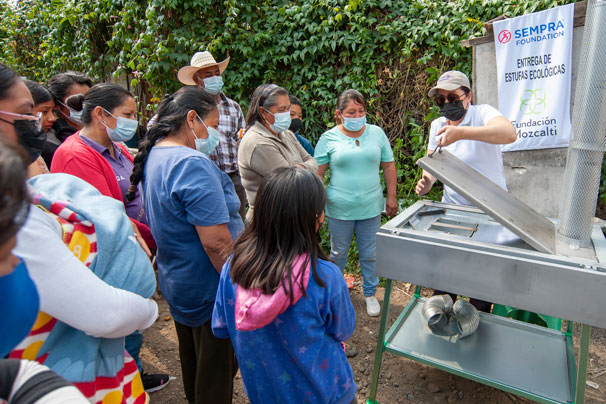 Community members in Mexico learn how to operate their new, cleaner-burning stoves