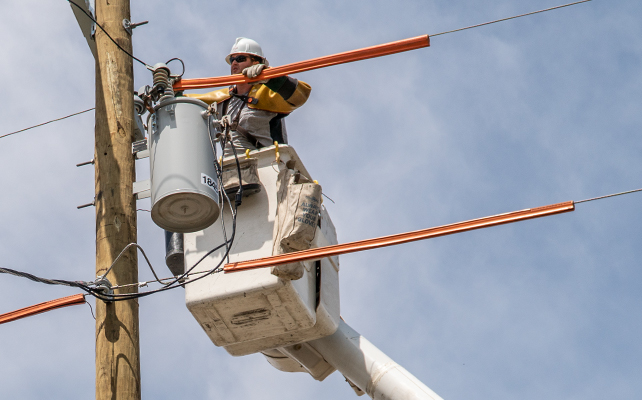 A Sempra lineman fixing a power line